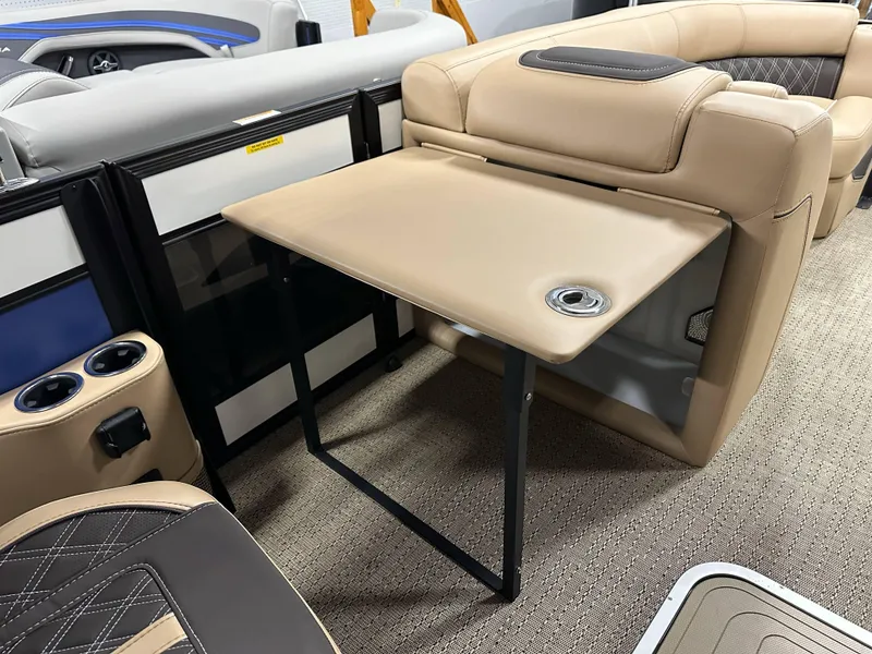 Slide: The Image of 2025 Barletta Lusso 23UC interior with beige seating and foldable table. - 12