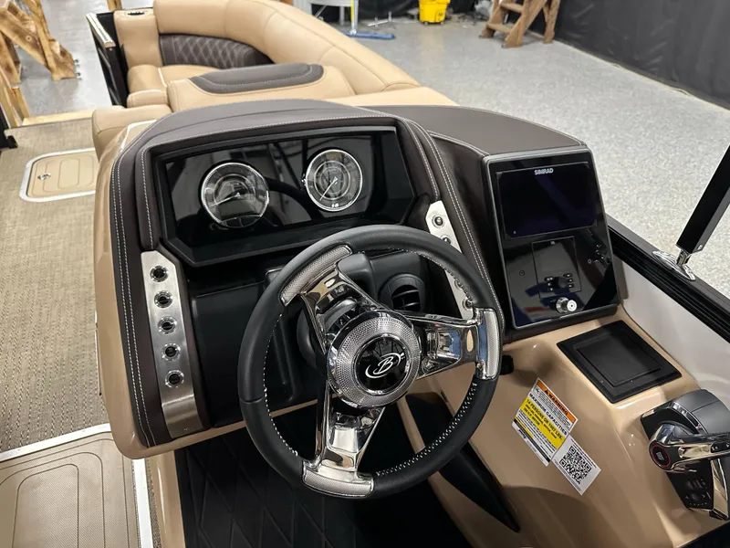 Slide: The Image of 2025 Barletta Lusso 23UC boat dashboard with steering wheel and control panel. - 15