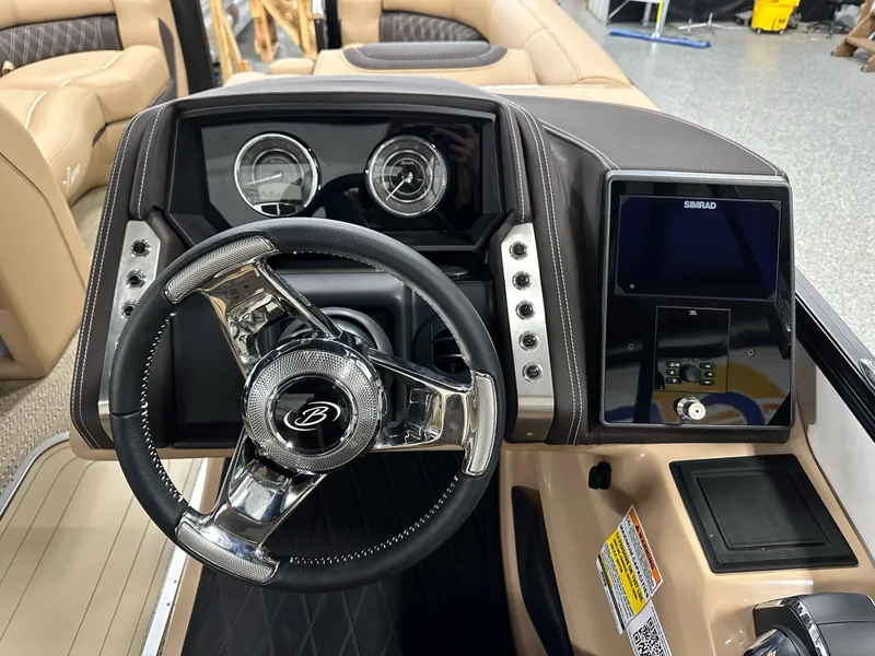 Slide: The Image of 2025 Barletta Lusso 23UC boat dashboard with steering wheel and control panel. - 16