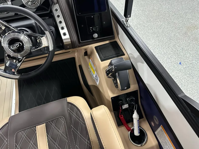 Slide: The Image of 2025 Barletta Lusso 23UC boat interior with steering wheel and control panel. - 17
