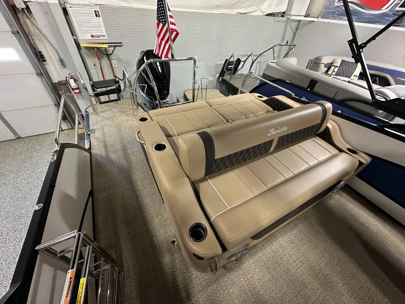 Slide: The Image of 2025 Barletta Lusso 23UC pontoon boat interior with tan seating and cup holders. - 18