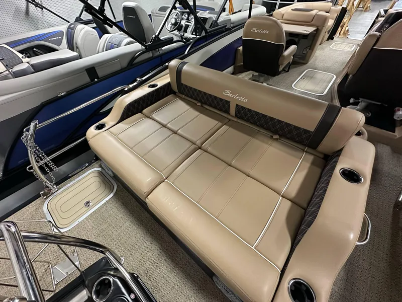 Slide: The Image of 2025 Barletta Lusso 23UC pontoon boat interior with luxurious tan seating and cup holders. - 19