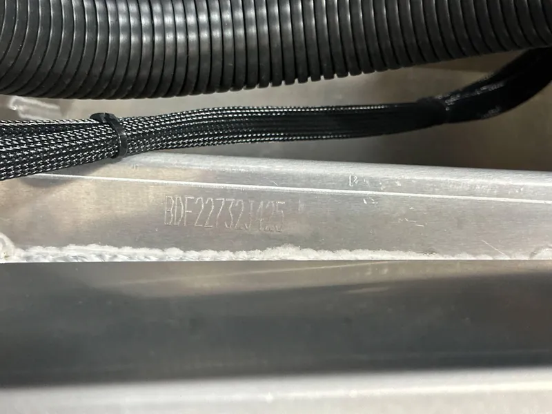 Slide: The Image of 2025 Barletta Lusso 23UC hull identification number with black wiring in the background. - 23