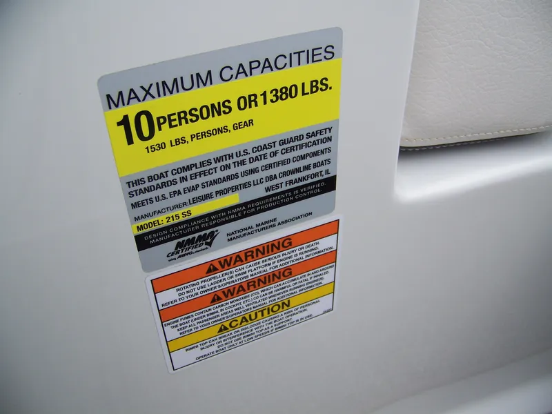 Slide: The Image of Crownline 215SS 2019 capacity label: 10 persons or 1380 lbs, safety warnings included. - 10