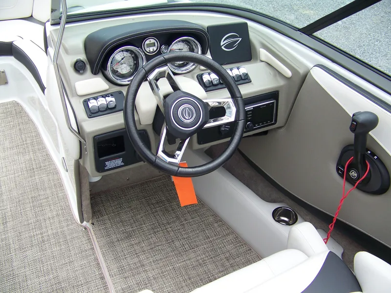 Slide: The Image of 2019 Crownline 215SS boat interior with steering wheel and dashboard controls. - 8
