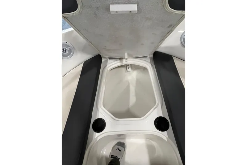 Slide: The Image of 2021 Bayliner VR6 Bowrider OB interior with cushioned seating on calm water. - 13