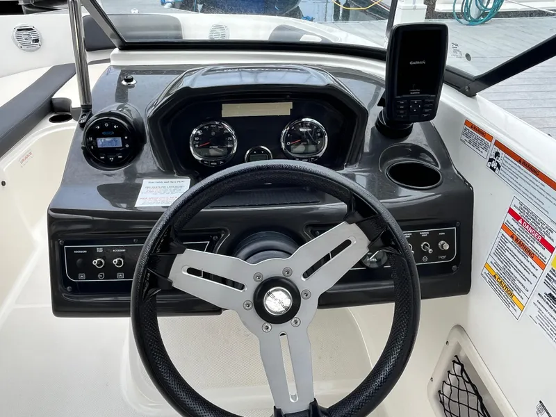 Slide: The Image of 2021 Bayliner VR6 Bowrider OB dashboard with steering wheel and control panel. - 3