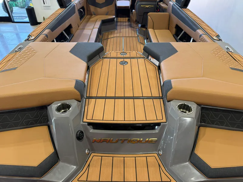Slide: The Image of 2025 Nautique Super Air Nautique GS24 interior with tan upholstery and sleek design. - 10