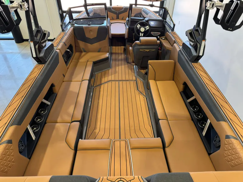 Slide: The Image of 2025 Nautique Super Air Nautique GS24 interior with luxurious tan seating and modern design. - 13