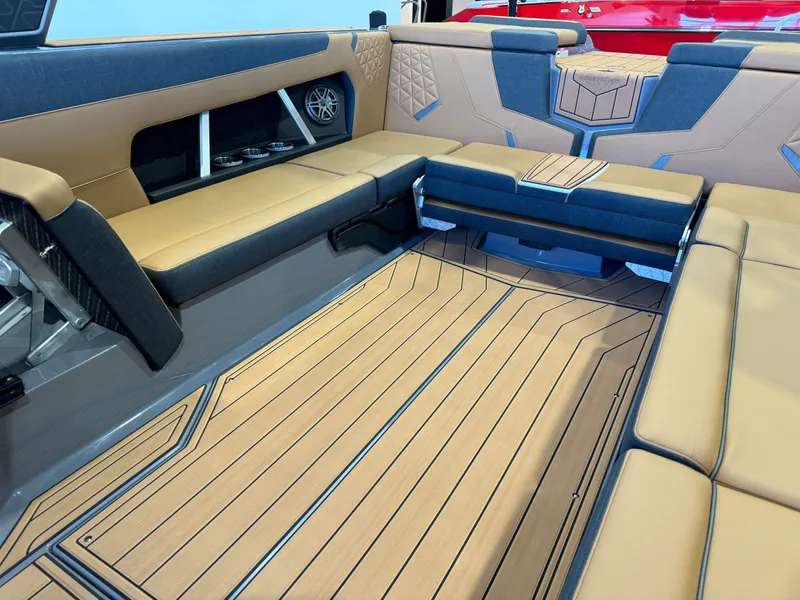 Slide: The Image of 2025 Nautique Super Air Nautique GS24 interior with tan and gray seating. - 15