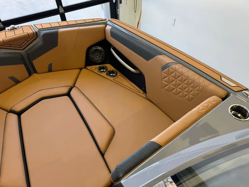 Slide: The Image of Luxurious interior of 2025 Nautique Super Air Nautique GS24 boat with tan upholstery. - 18