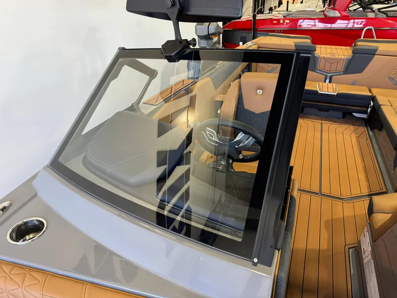 Slide: The Image of 2025 Nautique Super Air Nautique GS24 interior with tan upholstery and sleek design. - 20