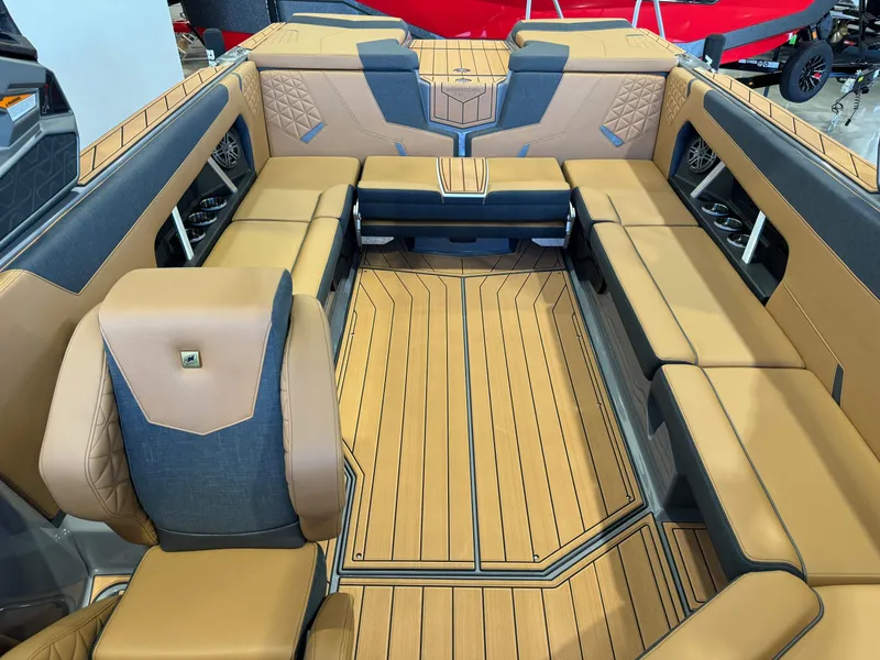 Slide: The Image of Luxurious interior of 2025 Nautique Super Air Nautique GS24 boat with tan and gray seating. - 22