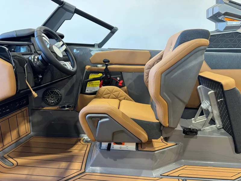 Slide: The Image of Interior of 2025 Nautique Super Air Nautique GS24 boat, featuring modern steering and seating. - 23