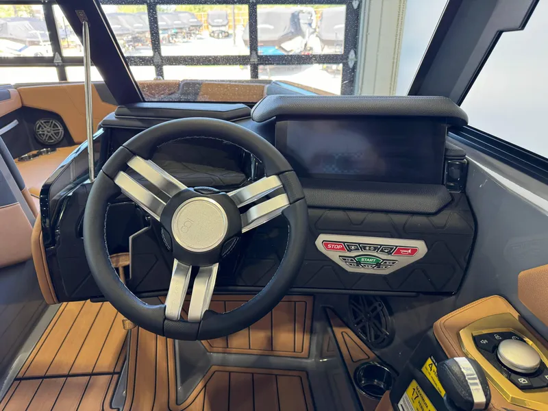 Slide: The Image of 2025 Nautique Super Air Nautique GS24 dashboard with steering wheel and control panel. - 27