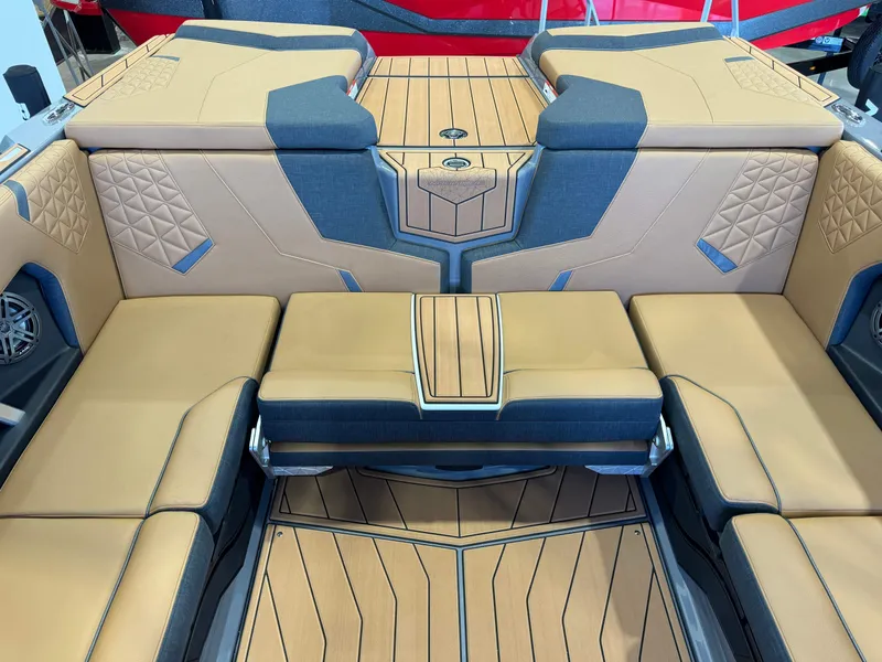 Slide: The Image of 2025 Nautique Super Air Nautique GS24 interior with tan and blue seating, luxury design. - 28