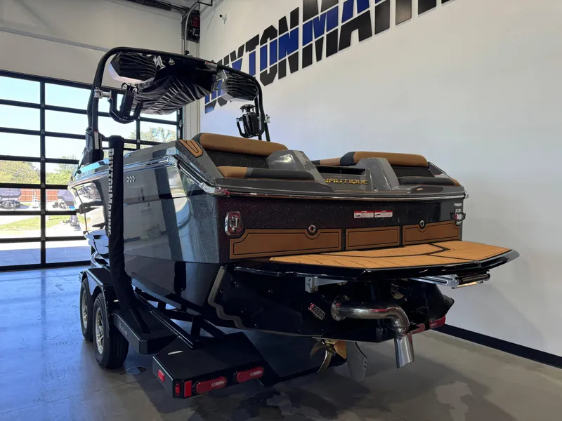 Slide: The Image of 2025 Nautique Super Air Nautique GS24 boat in showroom, rear view. - 5