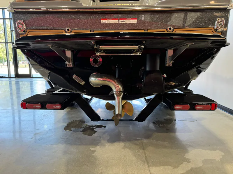 Slide: The Image of 2025 Nautique Super Air Nautique GS24 boat rear view, showcasing propeller and exhaust system. - 7