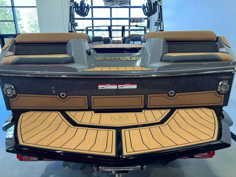 Slide: The Image of 2025 Nautique Super Air Nautique GS24 boat, rear view, in showroom. - 8
