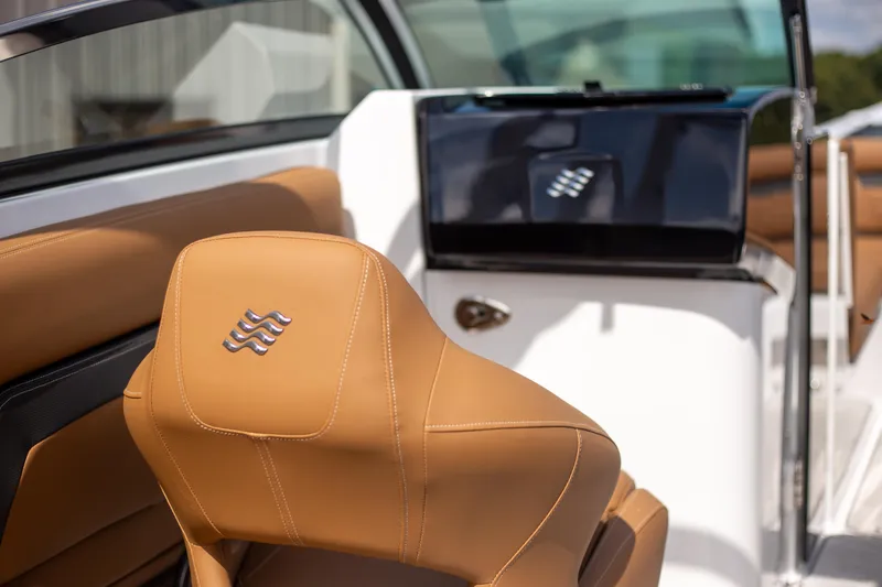 Slide: The Image of 2025 Four Winns HD5 boat interior with tan leather seating and sleek design. - 10