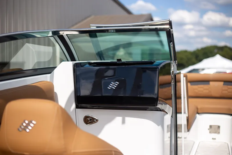 Slide: The Image of 2025 Four Winns HD5 boat interior with tan leather seats and sleek design. - 11