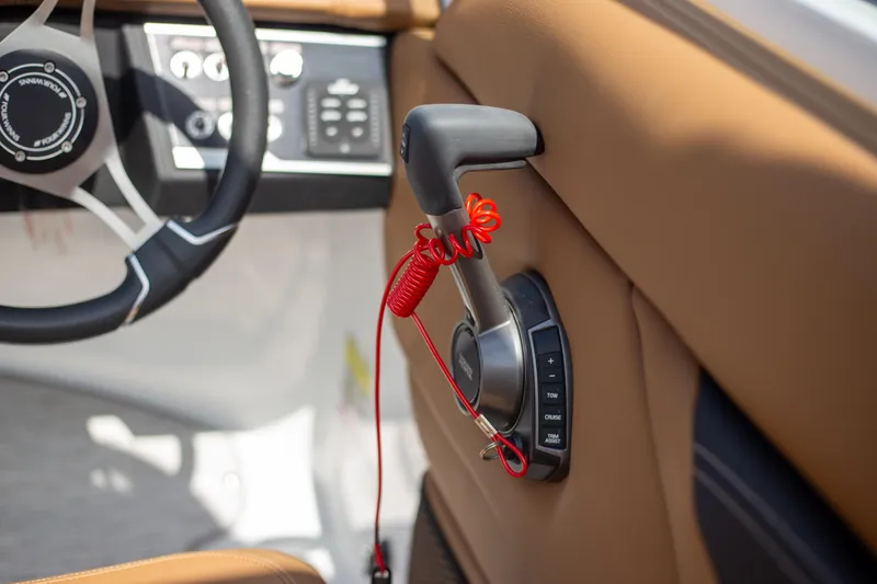 Slide: The Image of 2025 Four Winns HD5 boat throttle control with red safety lanyard. - 14