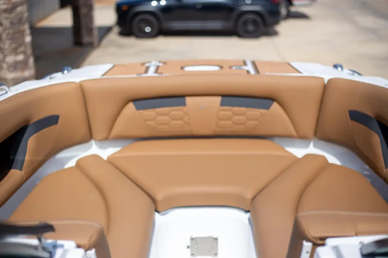 Slide: The Image of 2025 Four Winns HD5 boat interior with tan leather seating. - 15