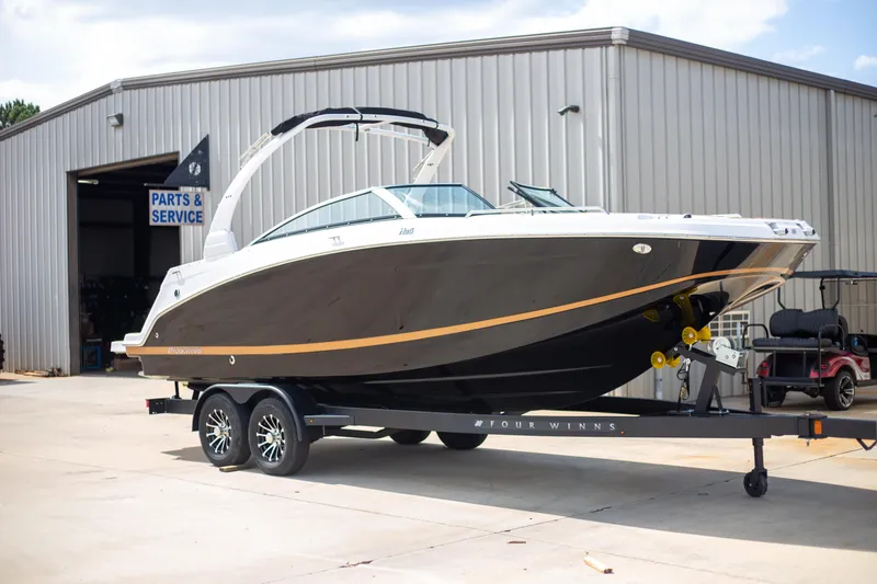 Slide: The Image of 2025 Four Winns HD5 boat on trailer outside service building. - 3