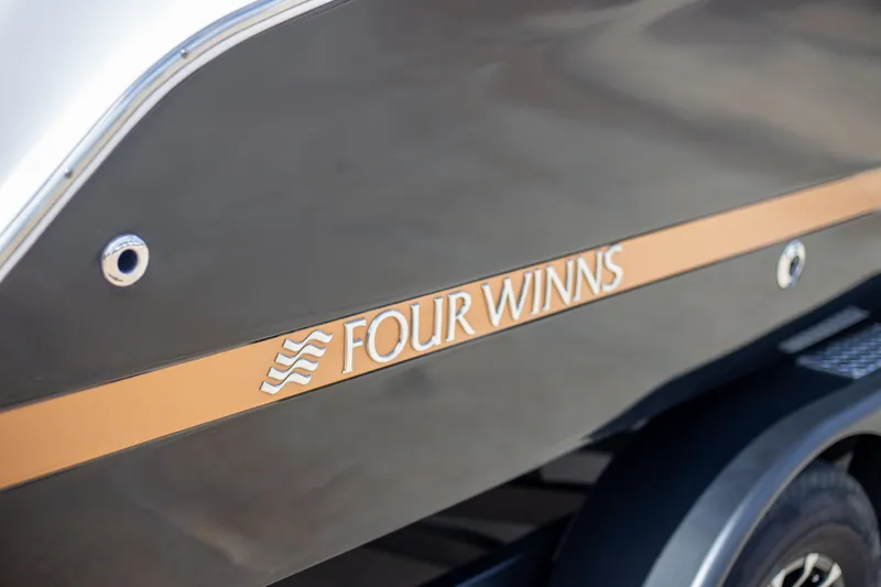 Slide: The Image of 2025 Four Winns HD5 boat side view with logo. - 5