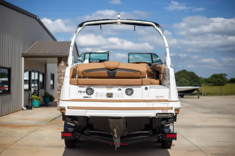 Slide: The Image of 2025 Four Winns HD5 boat parked outdoors on a sunny day. - 6