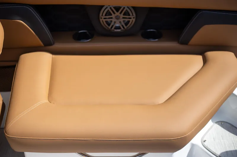 Slide: The Image of 2025 Four Winns HD5 boat interior with tan leather seating and speaker system. - 9