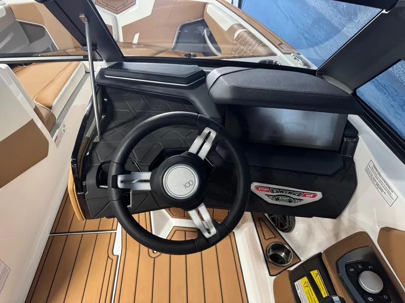 Slide: The Image of 2025 Nautique Super Air Nautique GS24 boat dashboard with steering wheel and controls. - 12