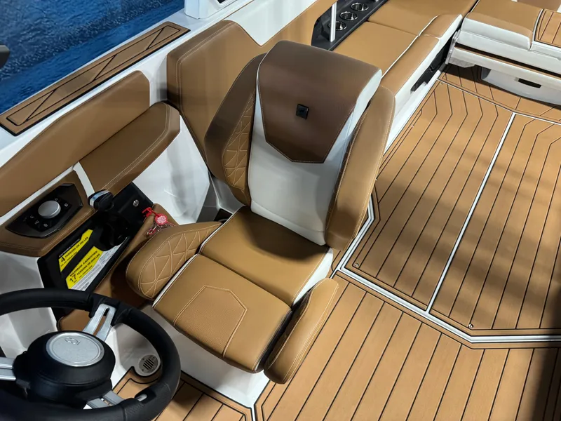 Slide: The Image of 2025 Nautique Super Air Nautique GS24 interior with tan seating and sleek design. - 13