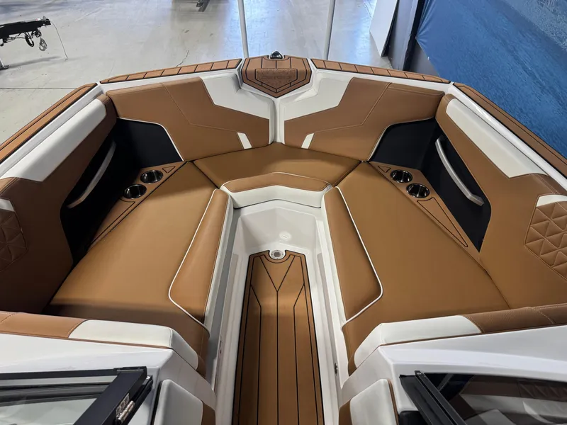 Slide: The Image of 2025 Nautique Super Air Nautique GS24 interior with tan and white seating. - 14