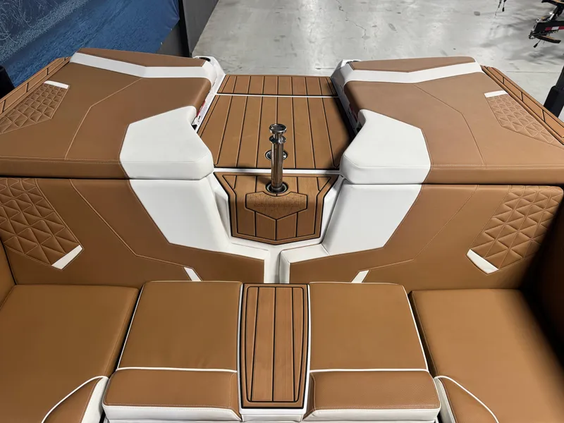 Slide: The Image of 2025 Nautique Super Air Nautique GS24 interior with tan and white upholstery. - 7