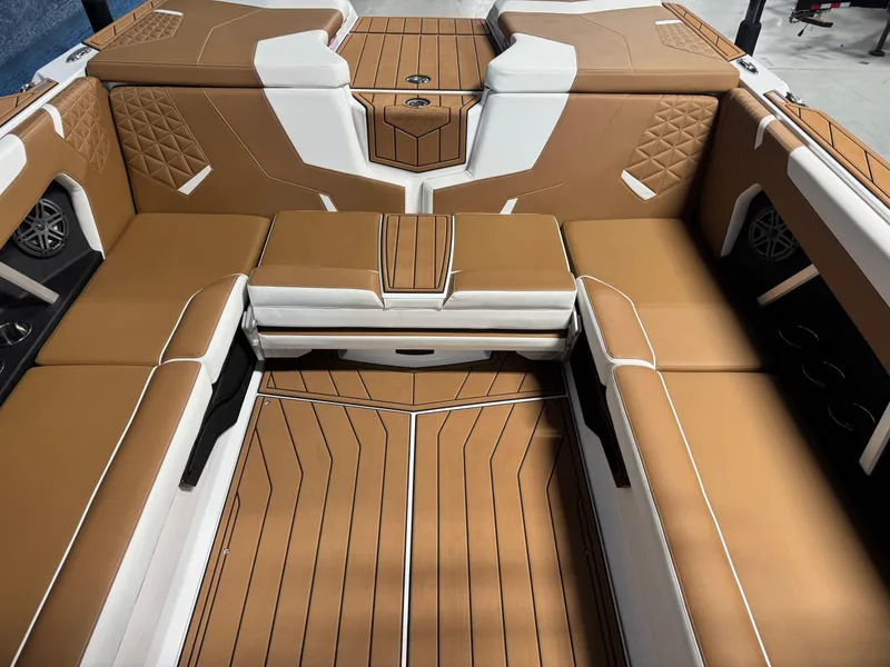 Slide: The Image of 2025 Nautique Super Air Nautique GS24 interior with tan and white seating. - 9