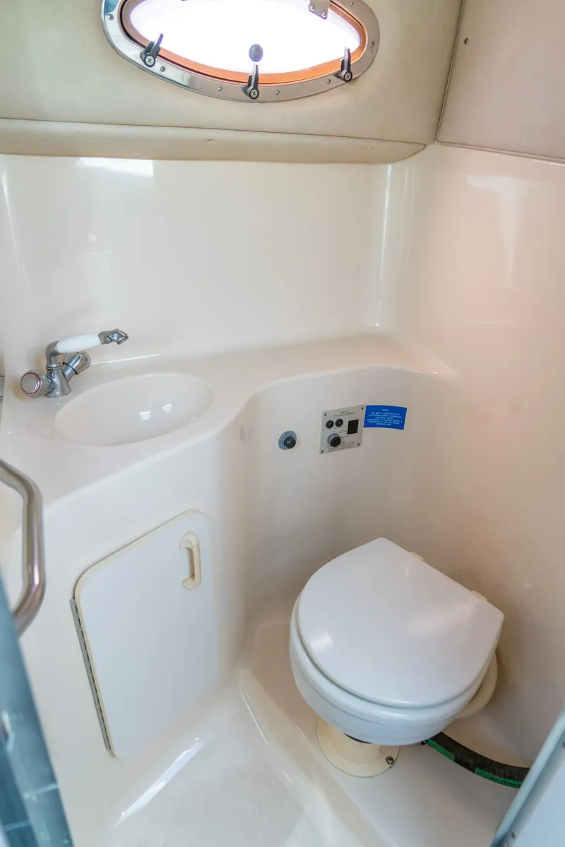 Slide: The Image of 1995 Sea Ray 250 Sundancer boat bathroom with sink and toilet. - 23