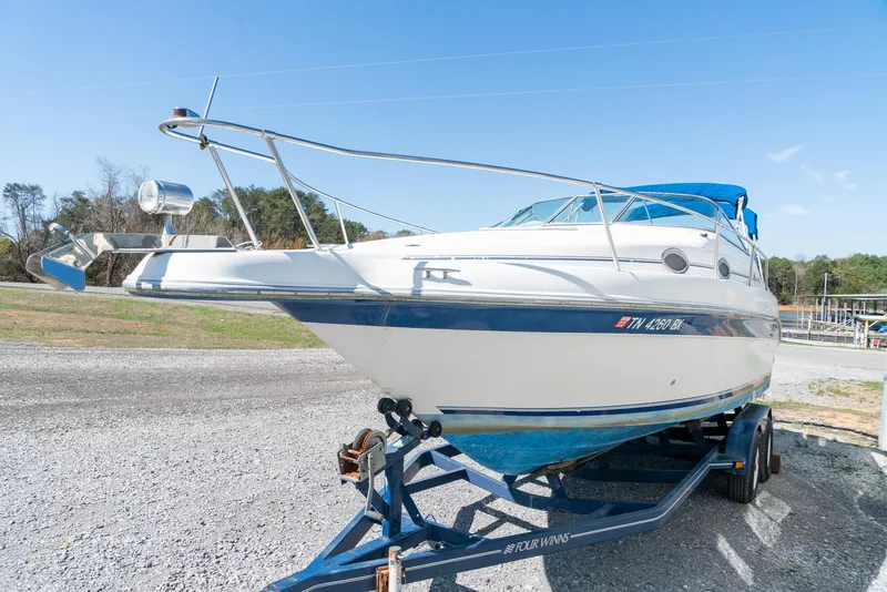 Slide: The Image of 1995 Sea Ray 250 Sundancer boat on trailer, parked outdoors under clear blue sky. - 4