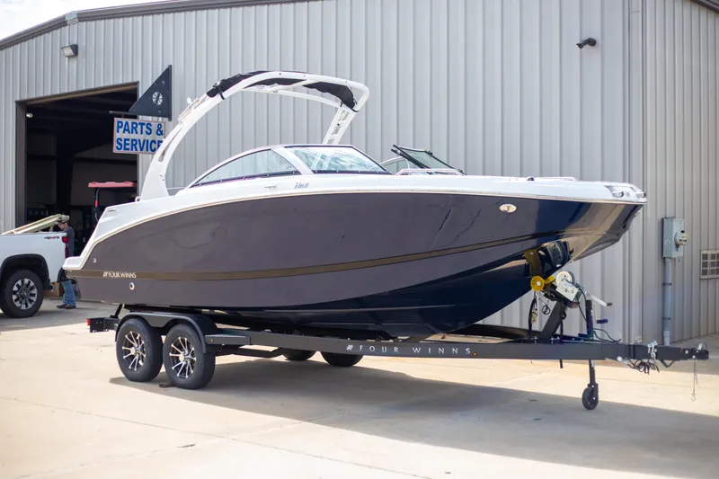 The Image of 2025 Four Winns HD3 boat on trailer outside service center. - 1