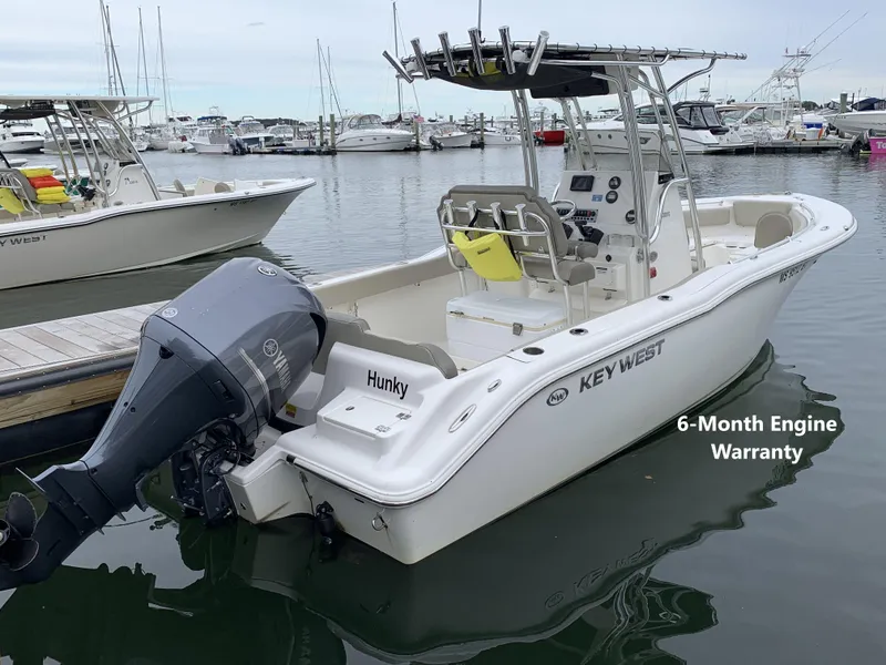 Slide: The Image of 2023 Key West 239 FS boat docked, featuring Yamaha engine and 6-month warranty. - 0