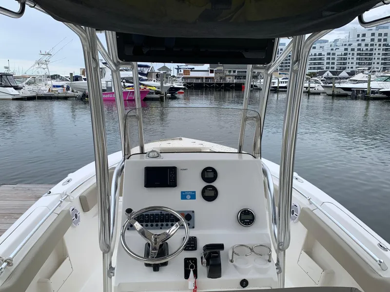 Slide: The Image of 2023 Key West 239 FS boat dashboard at marina, surrounded by docked boats. - 3