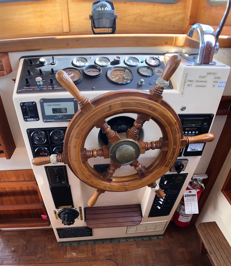 Slide: The Image of 1989 Nordic Tug 32 helm with wooden wheel and control panel. - 11