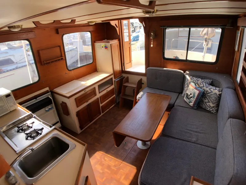 Slide: The Image of Interior of 1989 Nordic Tug 32 with kitchen, seating area, and wooden accents. - 17