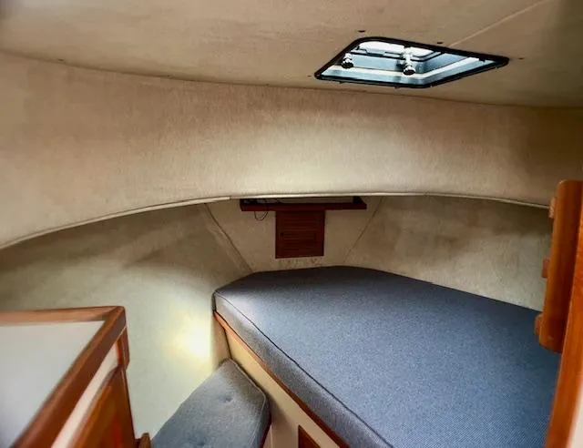 Slide: The Image of Cozy cabin interior of 1989 Nordic Tug 32 with a comfortable bed and overhead hatch. - 20