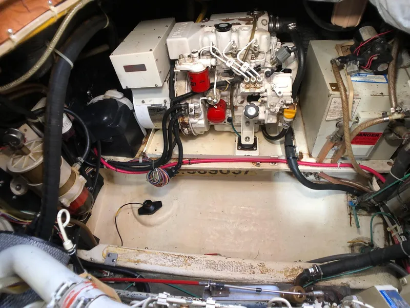 Slide: The Image of Engine room of a 1989 Nordic Tug 32, showcasing mechanical components and wiring. - 24