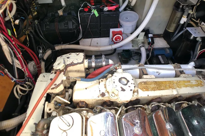 Slide: The Image of Engine room of a 1989 Nordic Tug 32, showcasing mechanical components and wiring. - 25