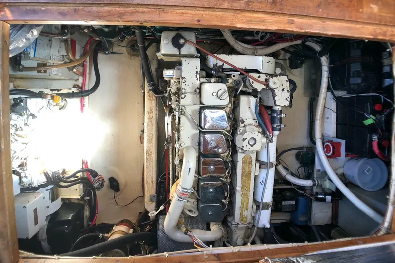 Slide: The Image of Engine room of a 1989 Nordic Tug 32, showcasing mechanical components and wiring. - 26