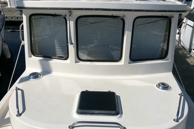 Slide: The Image of 1989 Nordic Tug 32 boat with three windows and deck hatch. - 5