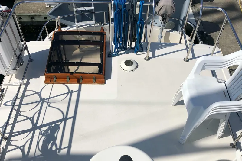 Slide: The Image of Deck of 1989 Nordic Tug 32 with hatch, railing, and stacked chairs. - 7