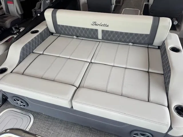 Slide: The Image of 2025 Barletta Lusso 23UC boat interior with luxurious seating and cup holders. - 11